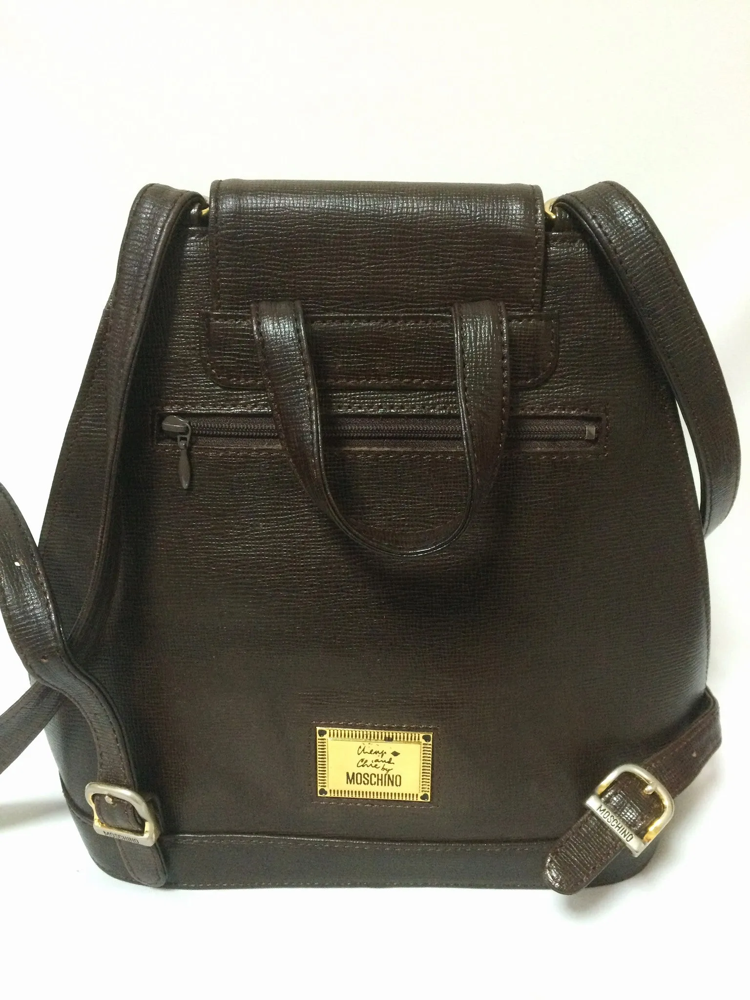 Vintage MOSCHINO genuine dark brown leather backpack with golden and black M logo motif from cheap and chic by moschino. Perfect daily bag. 060528r1